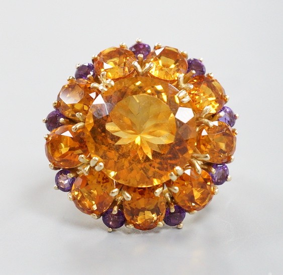 A large 14k, citrine and amethyst cluster set flower head dress ring, with diamond chip set shoulders, size H, gross weight 11.4 grams.